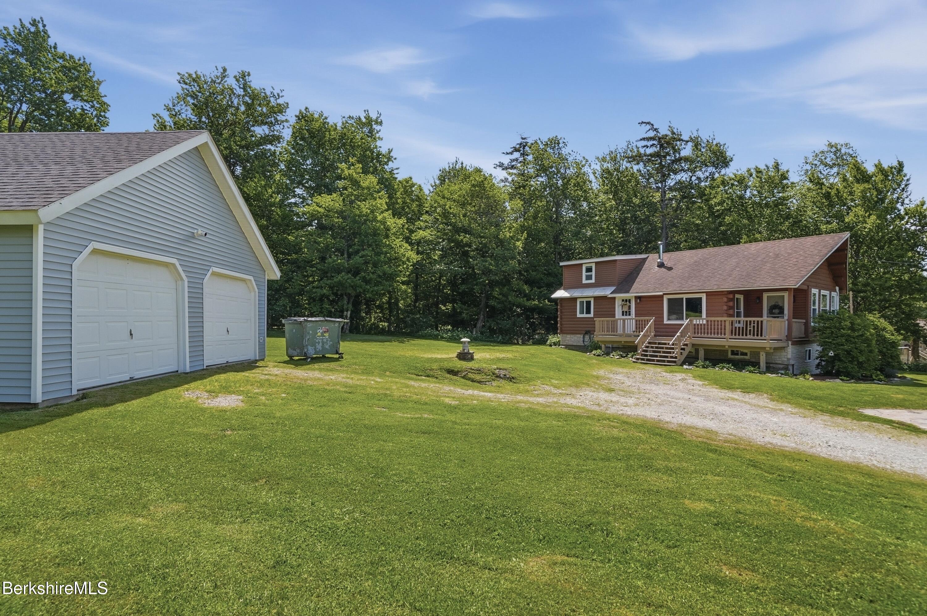 4 David Drive Peru, MA 01235 - Photo 2 of 44 a front view of a house with a garden