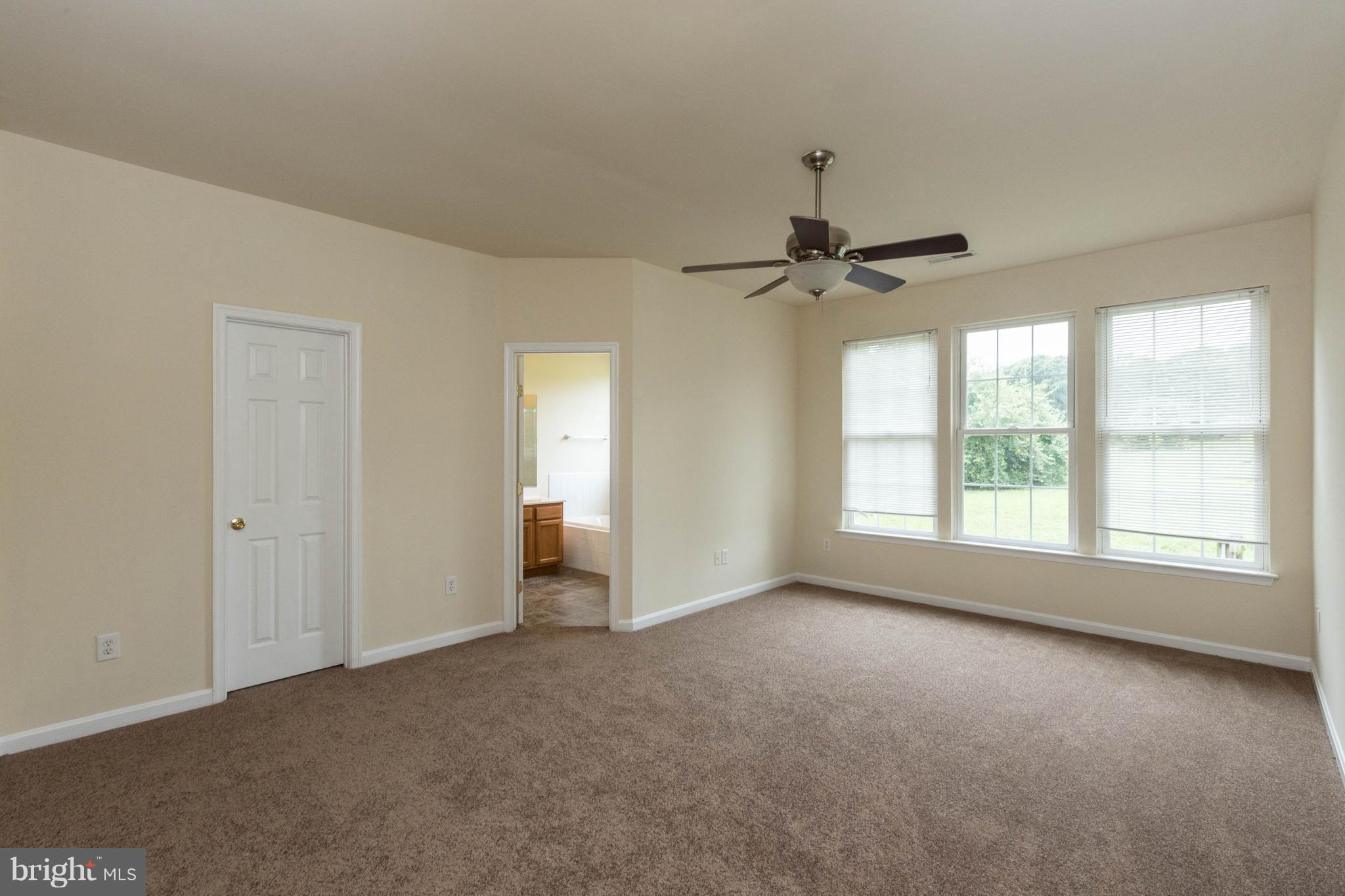 11207 Rawhide Road Lusby, MD 20657 - Photo 12 of 25 a view of a livingroom with a ceiling fan and window