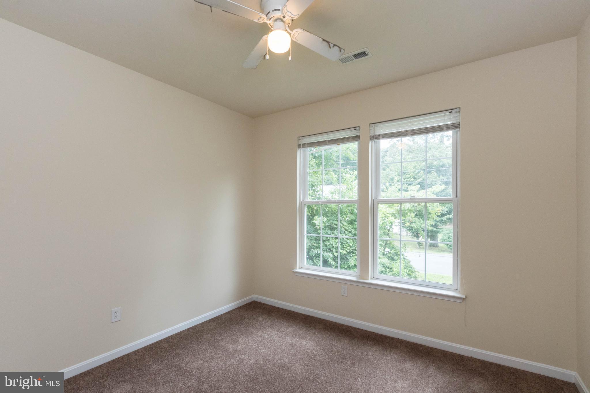 11207 Rawhide Road Lusby, MD 20657 - Photo 16 of 25 an empty room with a window and a fan