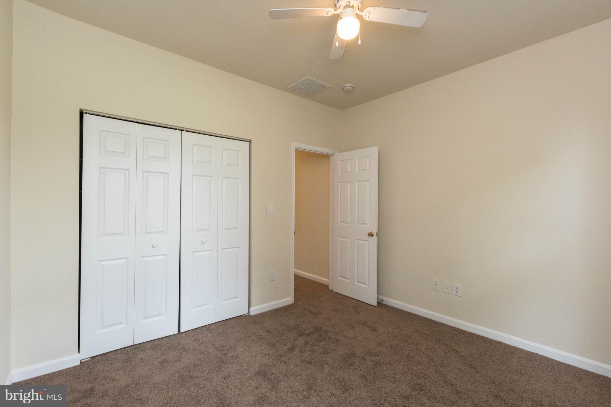 11207 Rawhide Road Lusby, MD 20657 - Photo 19 of 25 an empty room with a chandelier fan