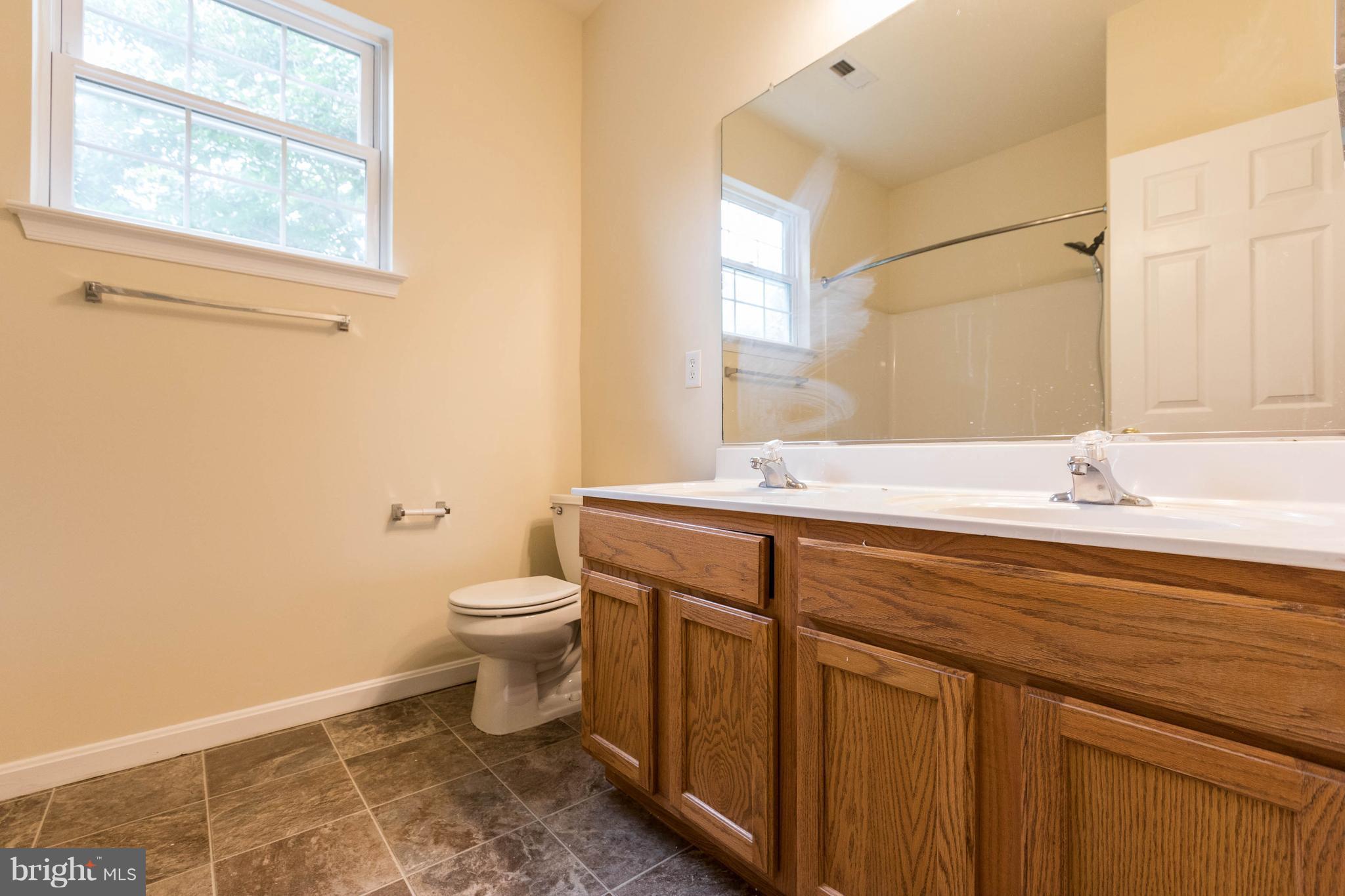 11207 Rawhide Road Lusby, MD 20657 - Photo 20 of 25 a bathroom with a sink and a toilet
