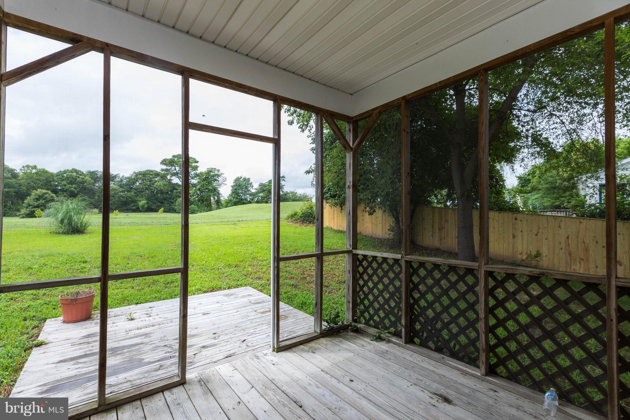 11207 Rawhide Road Lusby, MD 20657 - Photo 22 of 25 a view of a deck with wooden floor and floor to ceiling window