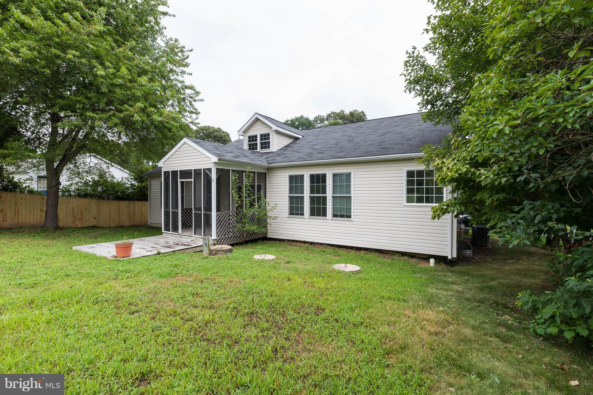 11207 Rawhide Road Lusby, MD 20657 - Photo 24 of 25 a view of a house with a yard and sitting area