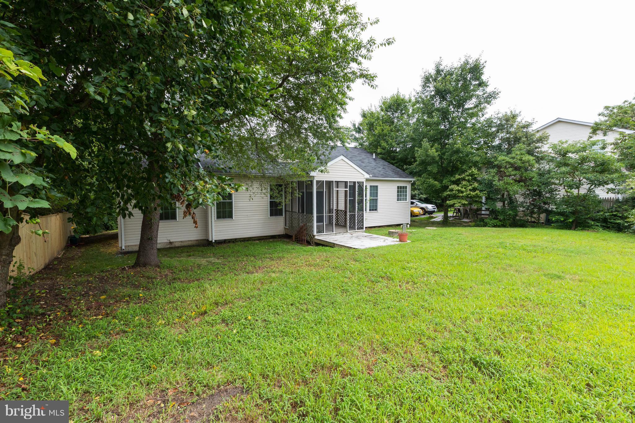 11207 Rawhide Road Lusby, MD 20657 - Photo 25 of 25 a front view of a house with yard and green space