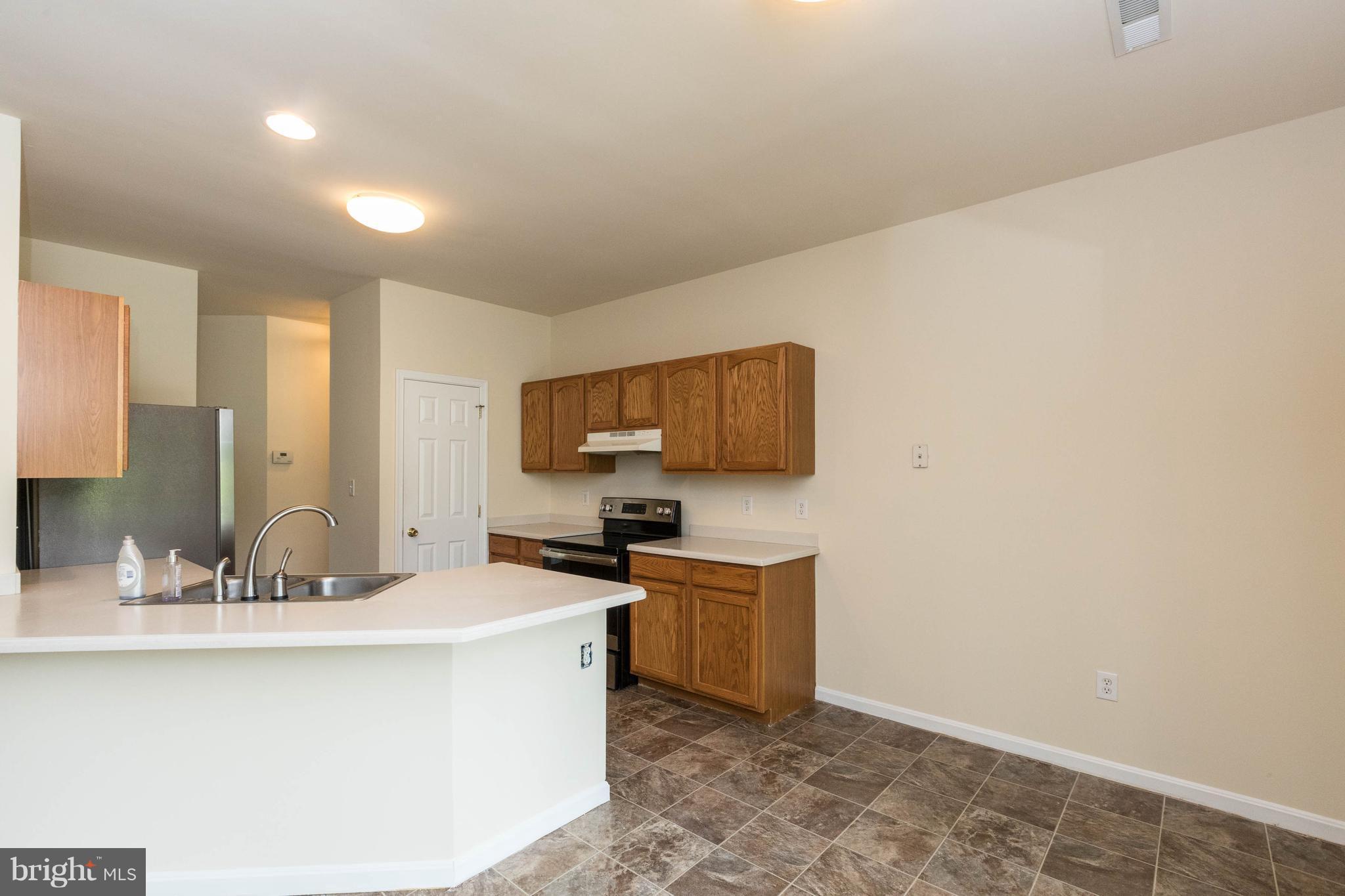 11207 Rawhide Road Lusby, MD 20657 - Photo 10 of 25 a kitchen with a sink cabinets and window