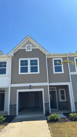 a front view of a house with garage