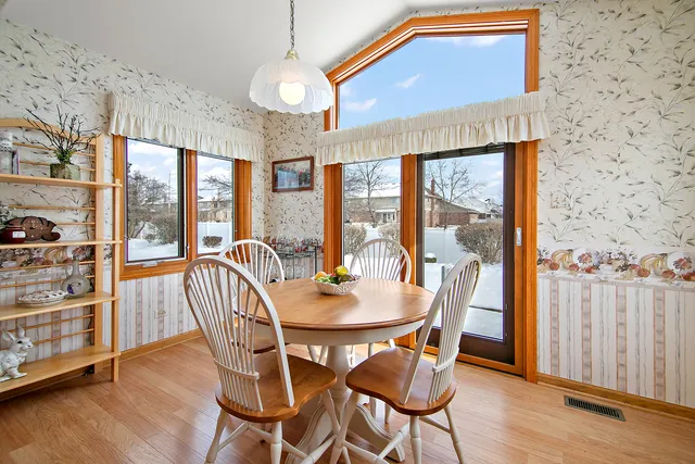 a view of a dining room with furniture window and wooden floor