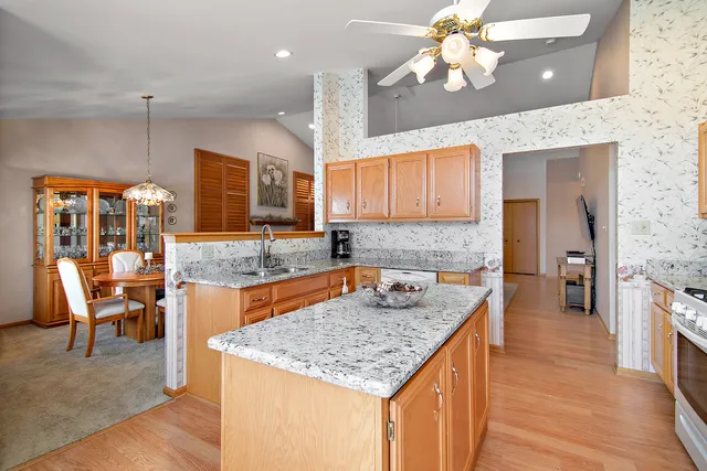 a kitchen with a counter top space a sink stainless steel appliances and cabinets