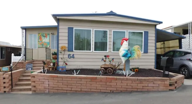 a view of a house with a small yard and plants