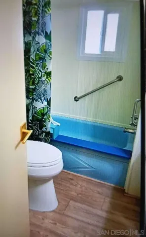 a hallway with sink and mirror