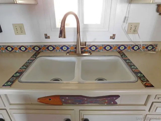 a kitchen with stainless steel appliances a stove refrigerator sink and cabinets