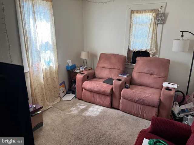 a bed sitting in a bedroom next to a book shelf