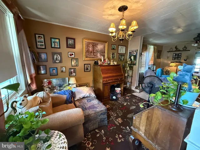 a living room filled with furniture chandelier and a chandelier