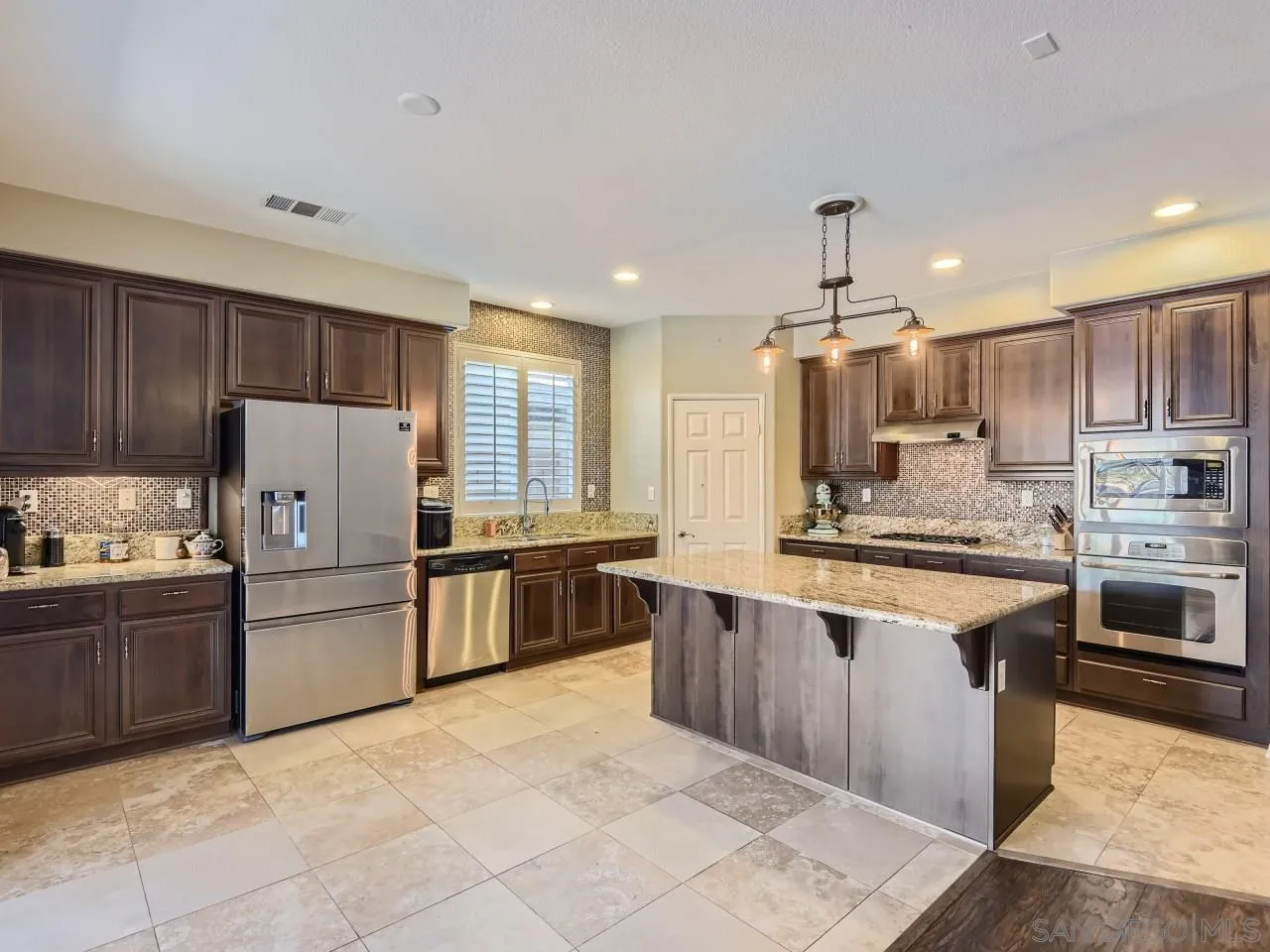 31183 Tiverton Road Menifee, CA 92584 - Photo 11 of 25 a kitchen with stainless steel appliances granite countertop a stove top oven a refrigerator a sink and dishwasher