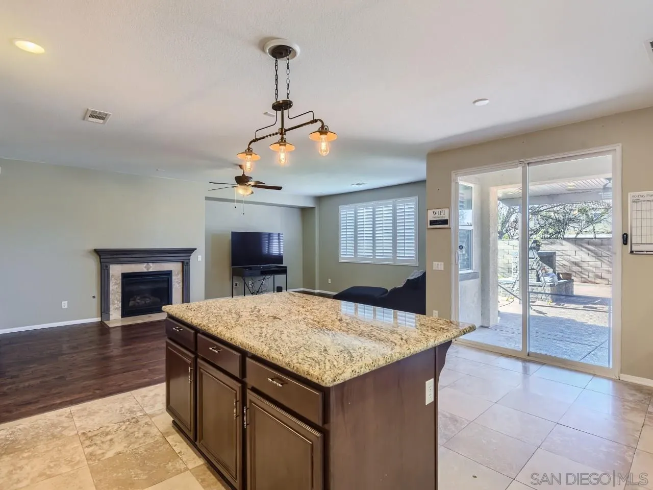 31183 Tiverton Road Menifee, CA 92584 - Photo 12 of 25 a kitchen with a stove a refrigerator and a fireplace