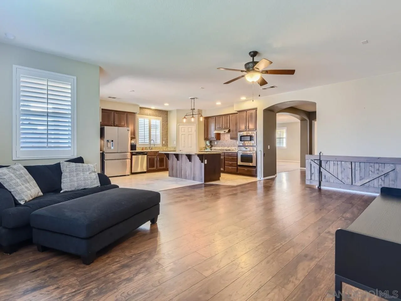 31183 Tiverton Road Menifee, CA 92584 - Photo 14 of 25 a living room with furniture and kitchen view