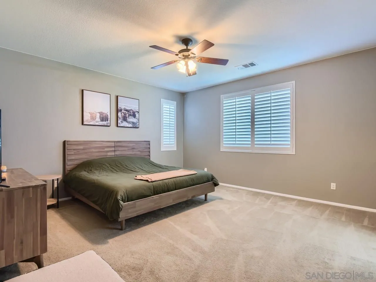 31183 Tiverton Road Menifee, CA 92584 - Photo 15 of 25 a bedroom with a bed and a chandelier