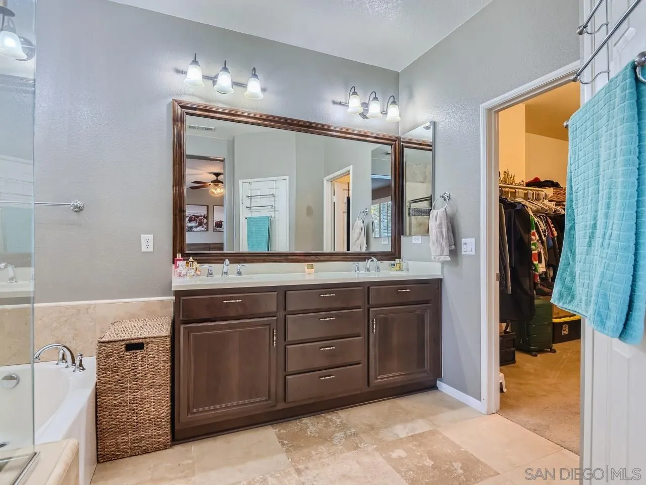 31183 Tiverton Road Menifee, CA 92584 - Photo 17 of 25 a spacious bathroom with a granite countertop sink and a mirror