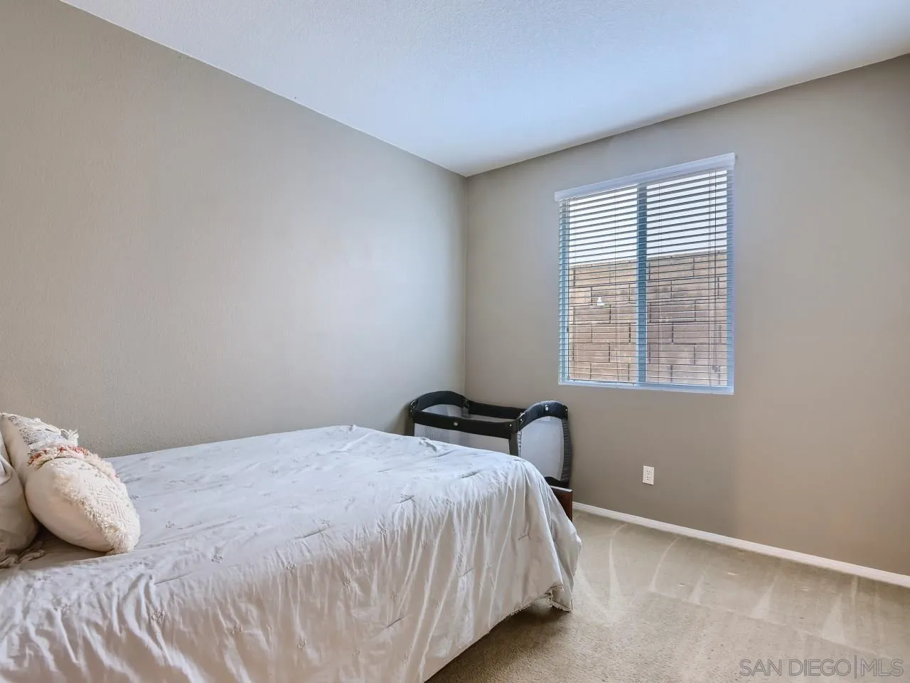 31183 Tiverton Road Menifee, CA 92584 - Photo 18 of 25 a bedroom with a bed and a window