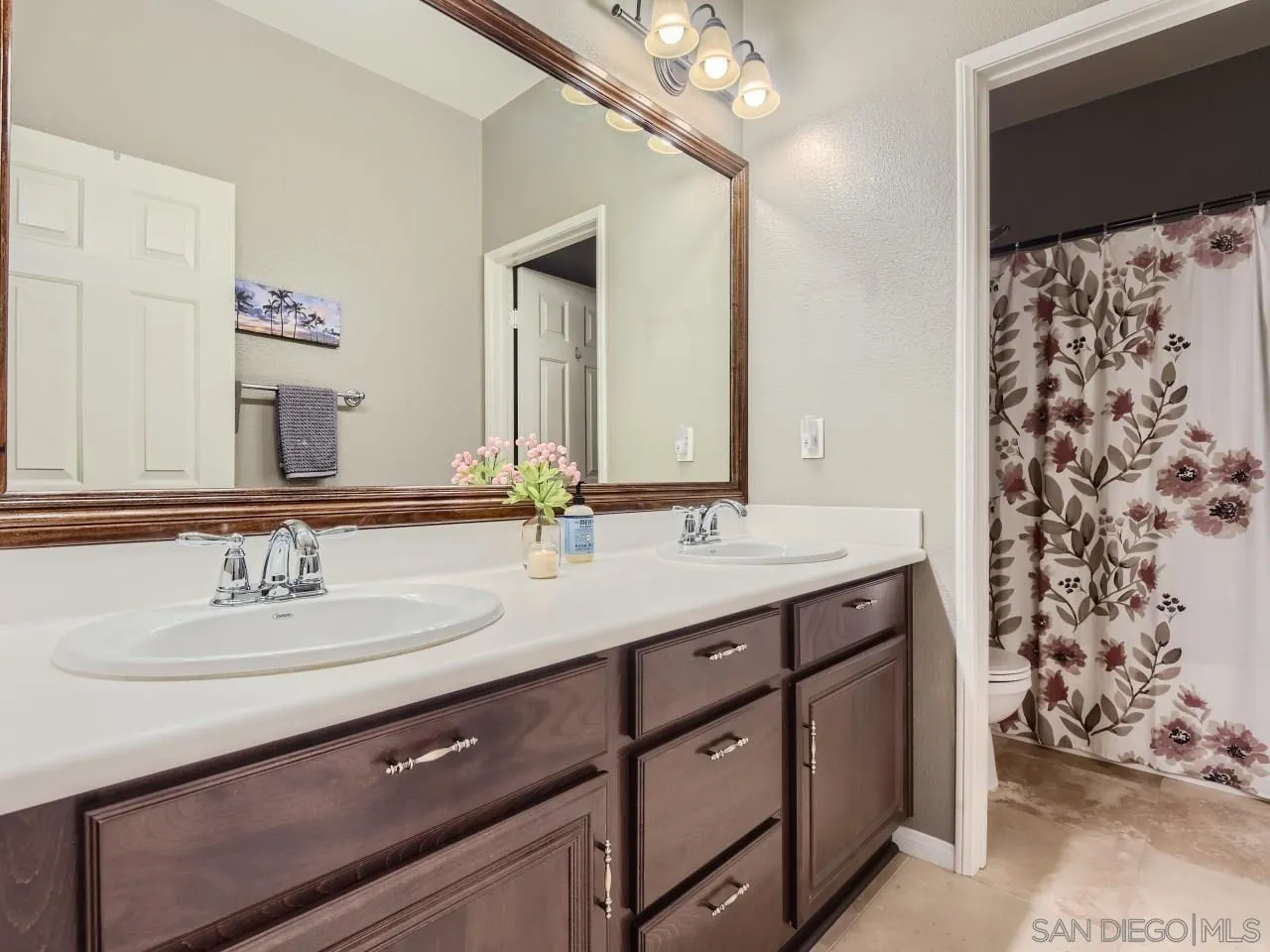 31183 Tiverton Road Menifee, CA 92584 - Photo 20 of 25 a bathroom with a double vanity sink and a mirror