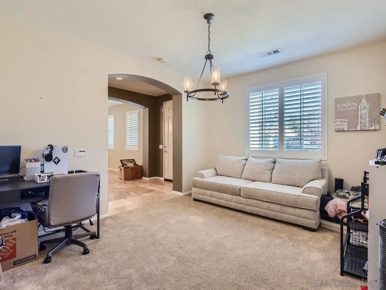 31183 Tiverton Road Menifee, CA 92584 - Photo 10 of 25 a living room with furniture a window and a chandelier