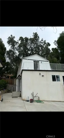 a view of house with backyard