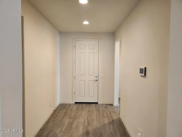 a view of a hallway with wooden floor