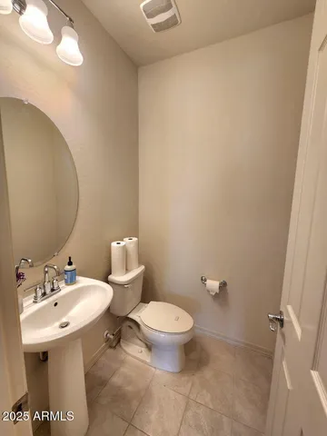 a bathroom with a sink mirror and toilet