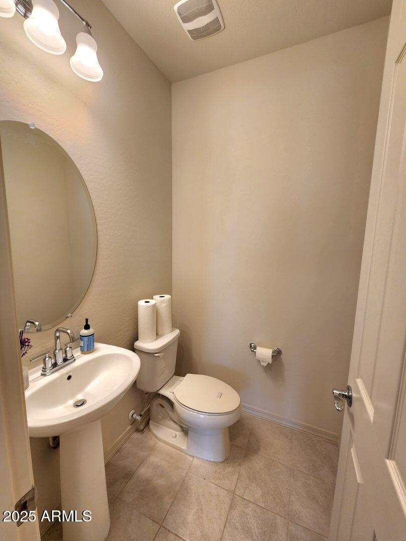 7198 West Bajada Road Peoria, AZ 85383 - Photo 19 of 36 a bathroom with a sink mirror and toilet