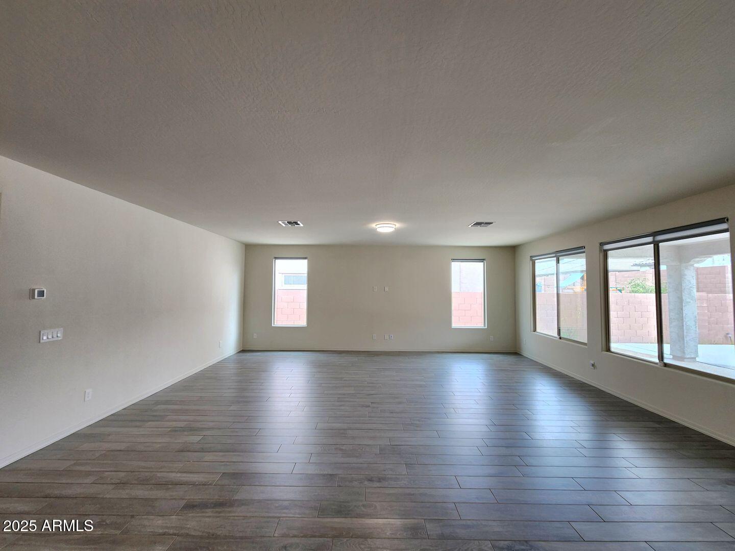 7198 West Bajada Road Peoria, AZ 85383 - Photo 21 of 36 an empty room with wooden floor and windows
