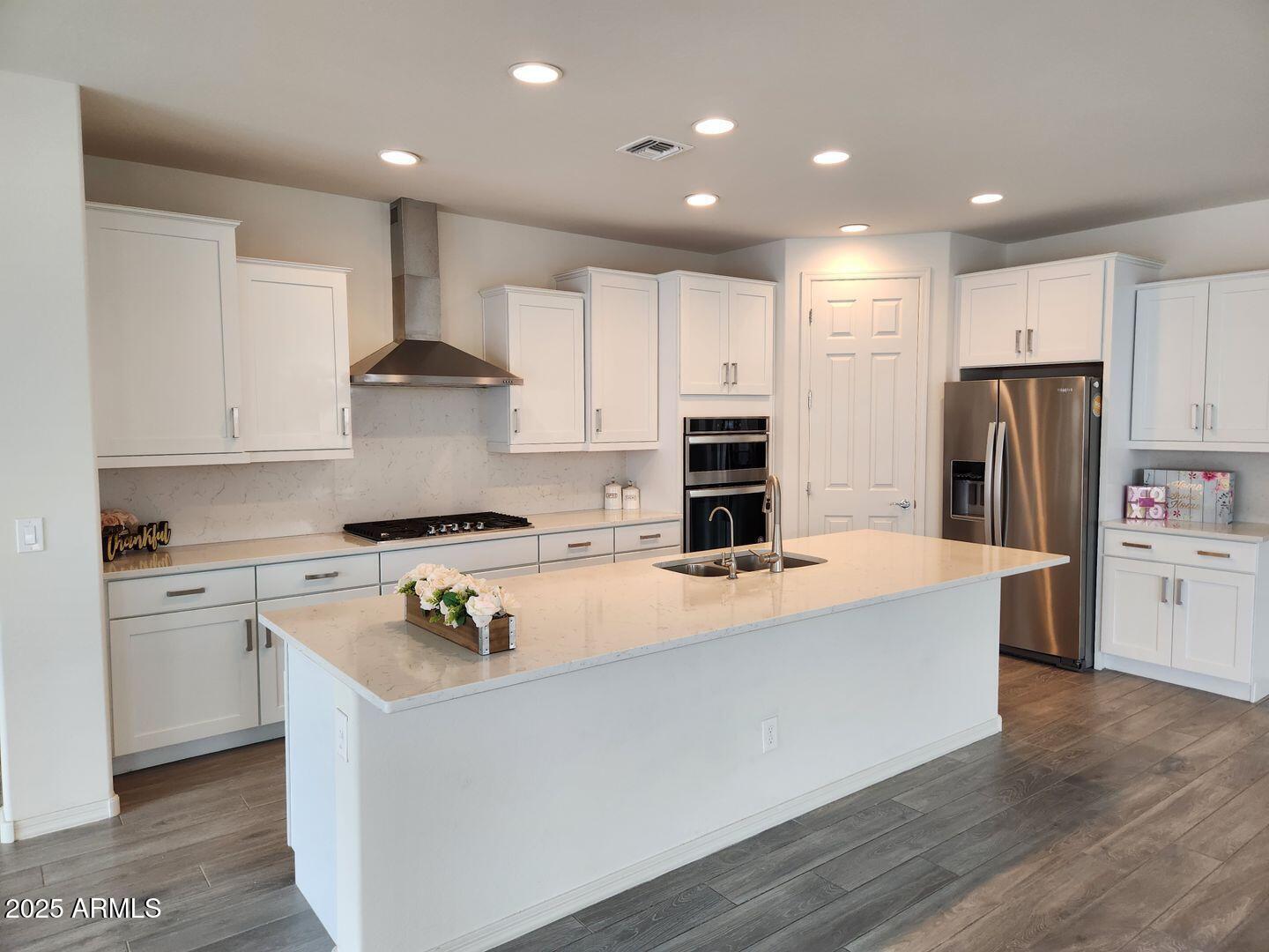 7198 West Bajada Road Peoria, AZ 85383 - Photo 23 of 36 a kitchen with stainless steel appliances a refrigerator a stove top oven and white cabinets