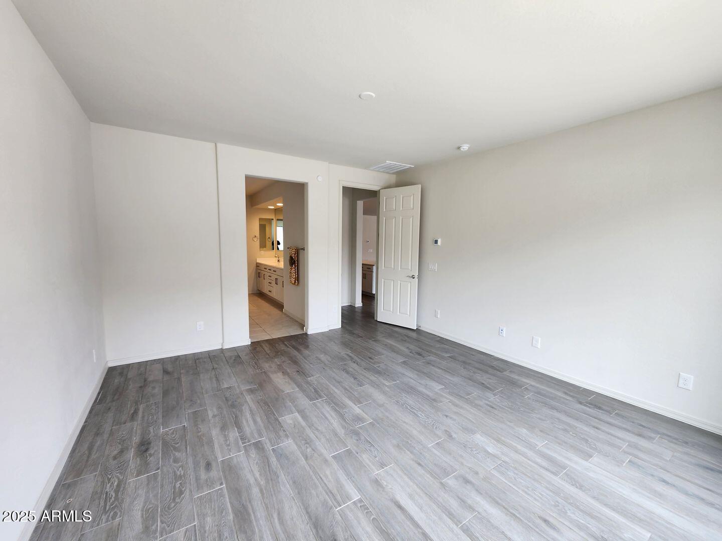 7198 West Bajada Road Peoria, AZ 85383 - Photo 28 of 36 a view of an empty room with wooden floor and window