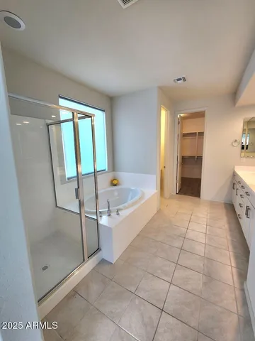a spacious bathroom with a tub and shower