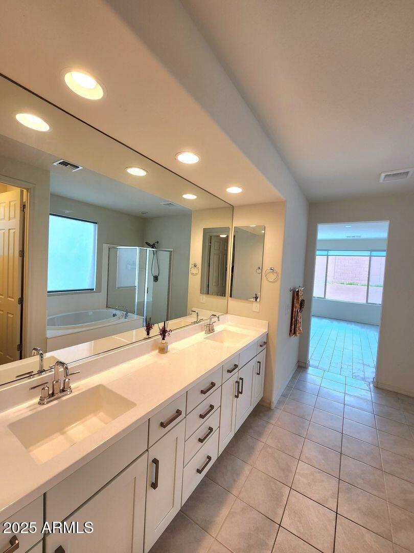 7198 West Bajada Road Peoria, AZ 85383 - Photo 33 of 36 a spacious bathroom with a granite countertop sink and a large mirror