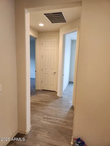 a view of hallway with wooden floor