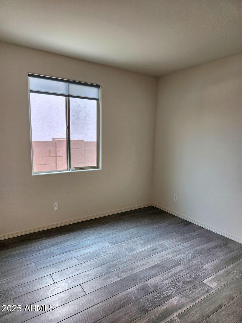 7198 West Bajada Road Peoria, AZ 85383 - Photo 5 of 36 an empty room with wooden floor and windows