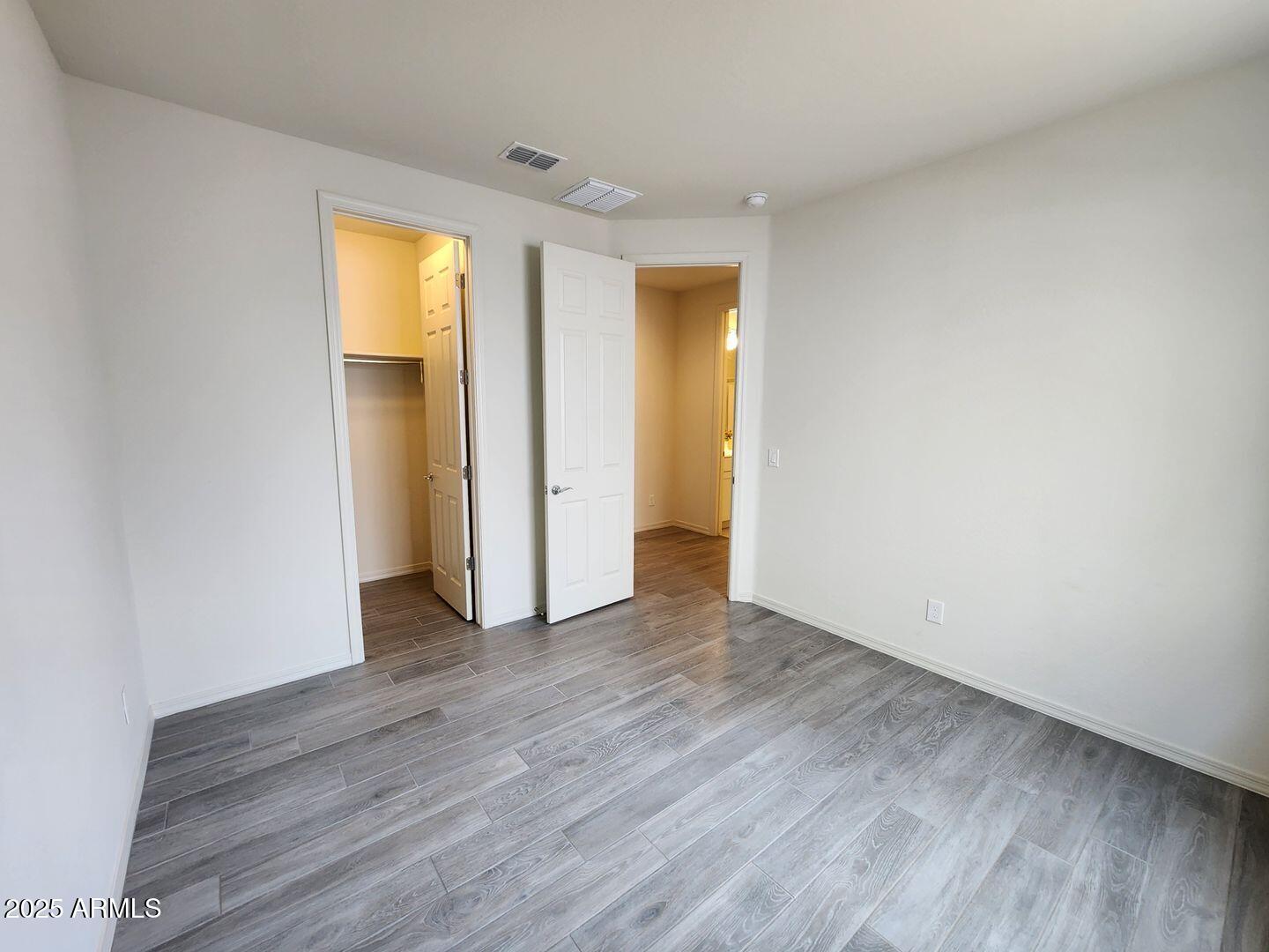 7198 West Bajada Road Peoria, AZ 85383 - Photo 6 of 36 a view of empty room with wooden floor and fan