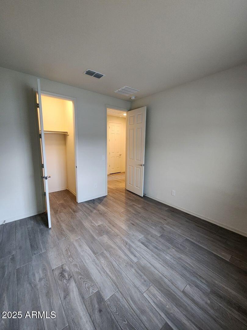 7198 West Bajada Road Peoria, AZ 85383 - Photo 9 of 36 a view of an empty room with wooden floor and a window
