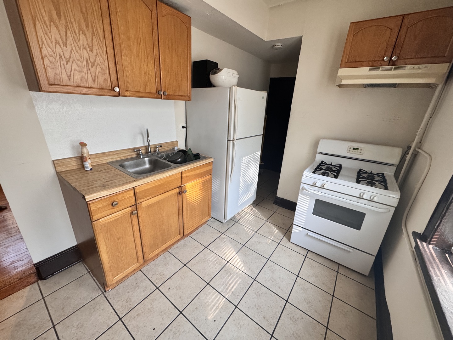 4459 West Jackson Boulevard Chicago, IL 60624 - Photo 2 of 14 a kitchen with a sink and a refrigerator