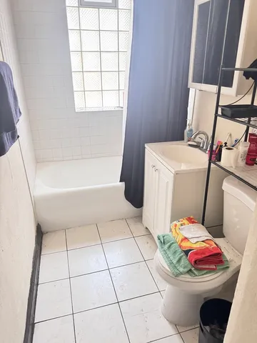 a bathroom with a sink toilet and window