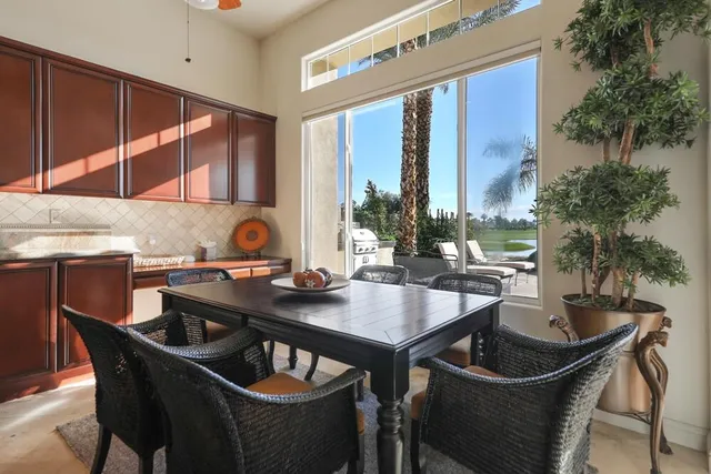 a kitchen with granite countertop a sink counter and chairs