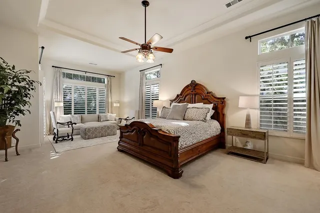 a bedroom with a bed window and a flat screen tv