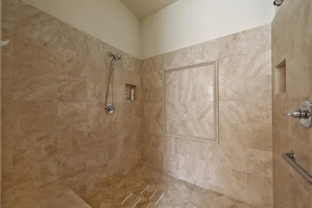 a bedroom with a bed couch and a mirror