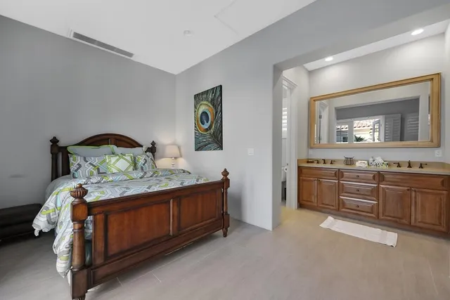 a bedroom with a bed and a television