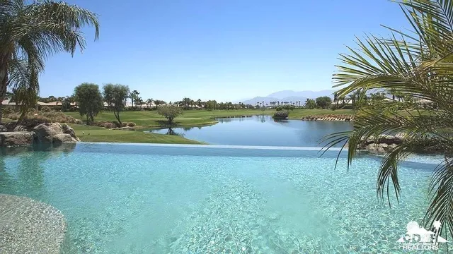 a view of a lake with palm trees