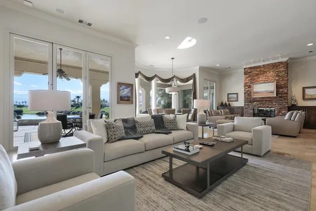 a living room with furniture a fireplace and a window