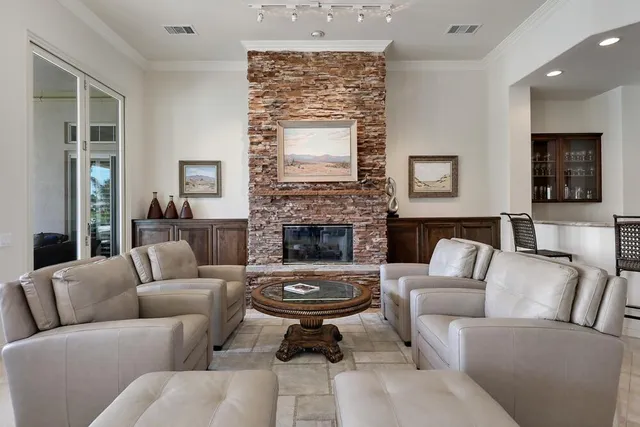 a living room with furniture and a large mirror