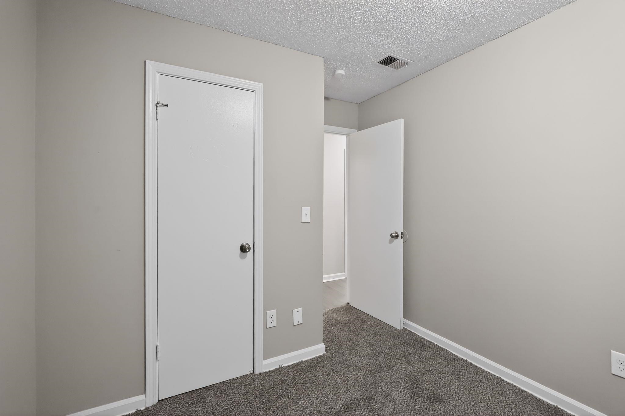4725 Lofts Road Memphis, TN 38118 - Photo 17 of 32 Unfurnished bedroom featuring a textured ceiling and dark carpet