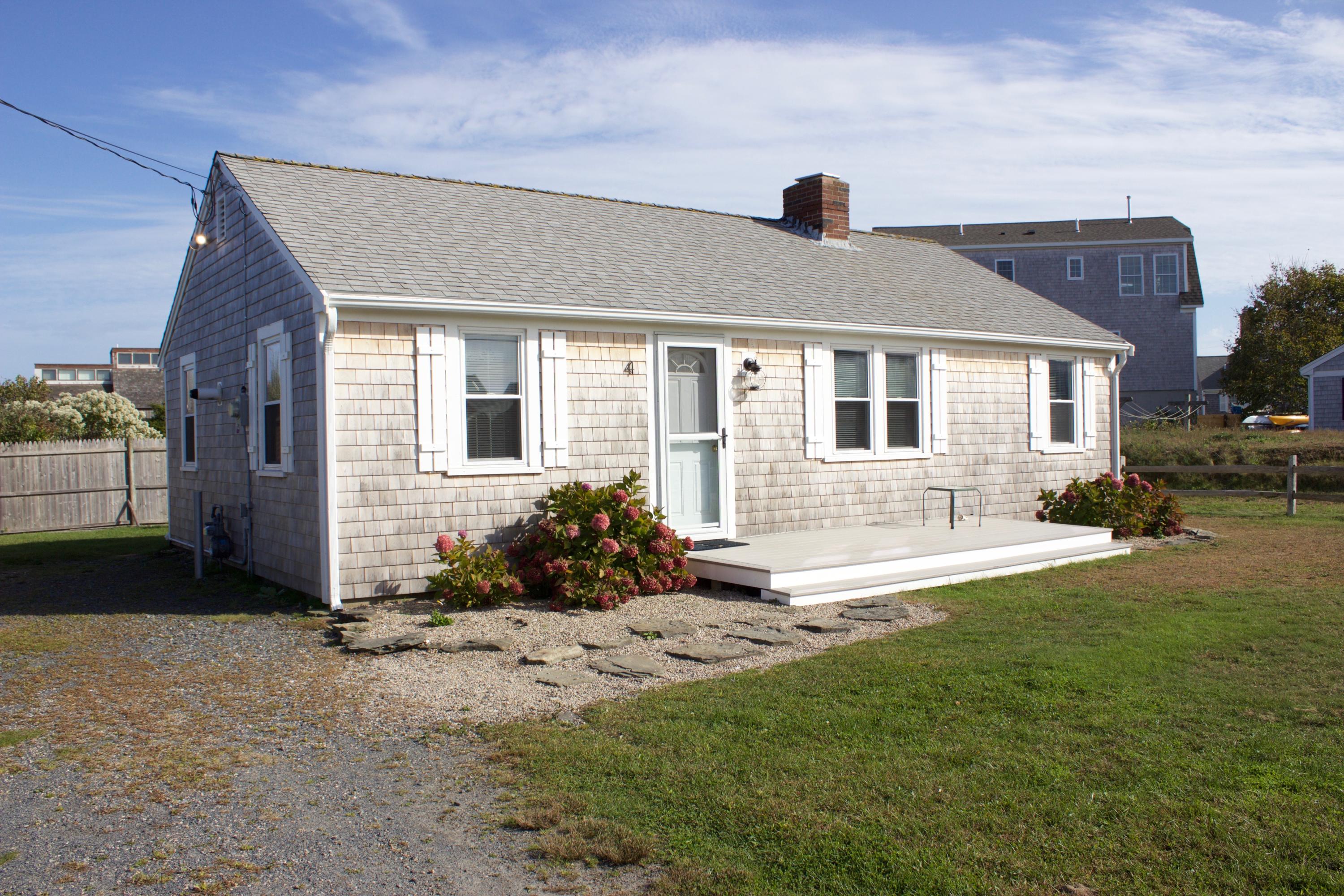 4 Beach Road West Dennis, MA 02670 - Photo 2 of 22 a front view of a house with a yard