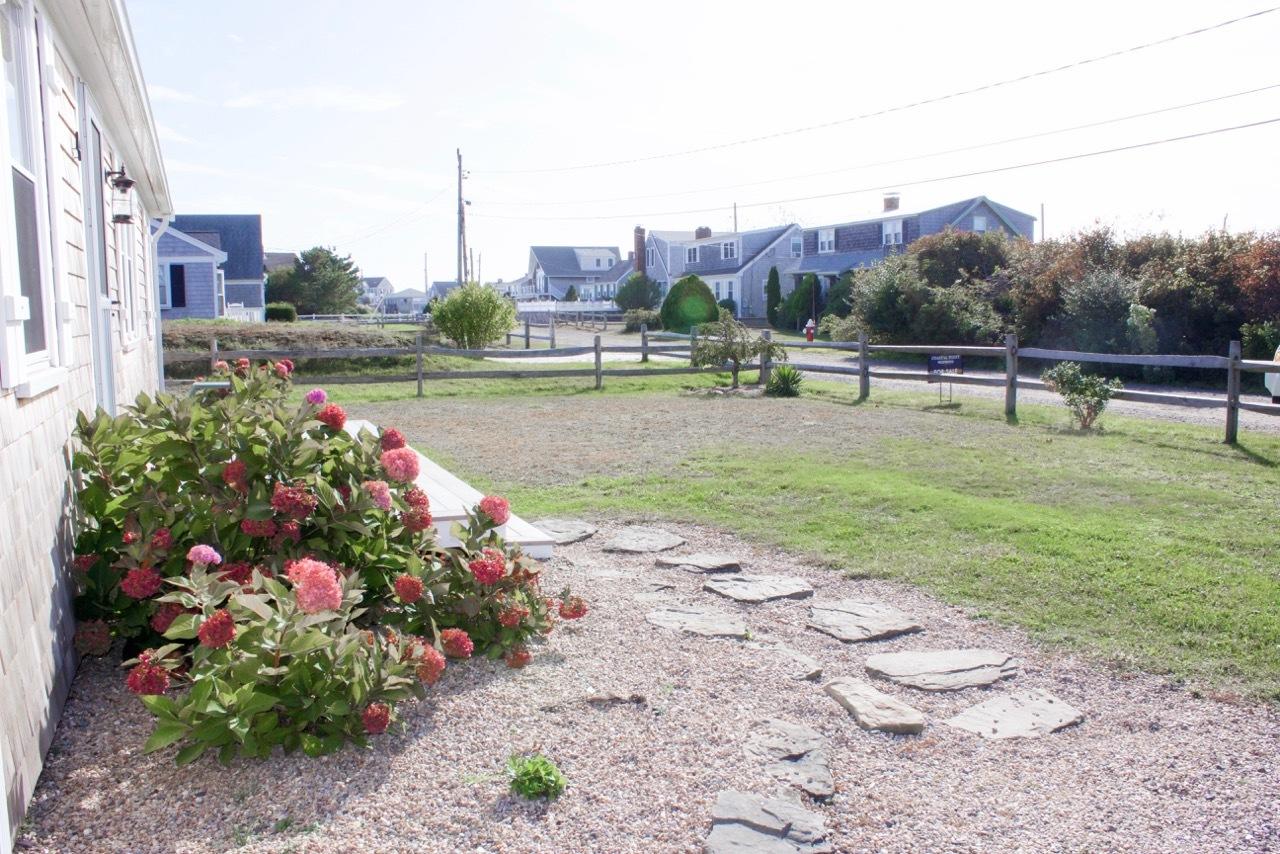 4 Beach Road West Dennis, MA 02670 - Photo 3 of 22 a view of a garden with a lake